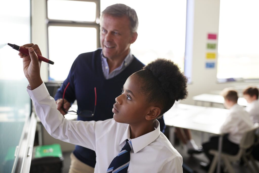 Inspired ICT Solutions Ltd - School student using Interactive Whiteboard during Lessons
